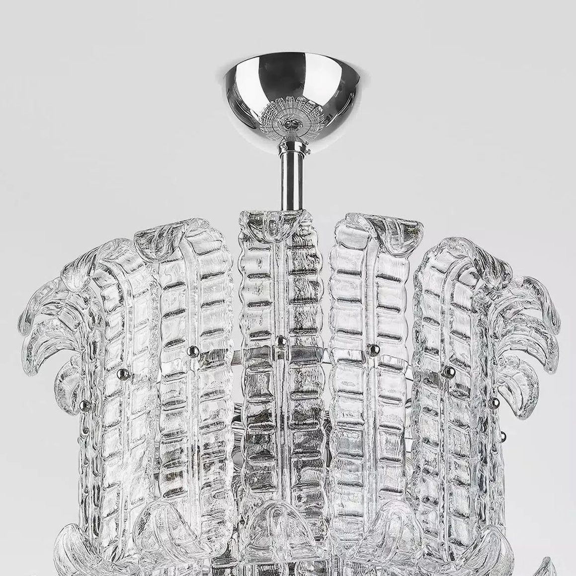 Calista chandelier upper glass section tight close-up showing ribbed clear glass panels and polished chrome fasteners