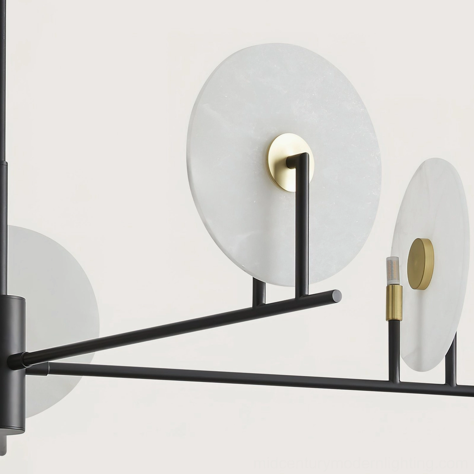Close-up detail of frosted alabaster disc, black metal arms and brass G9 bulb holders on chandelier