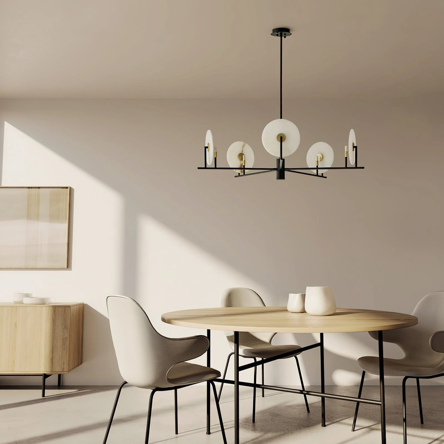 Modern alabaster disc chandelier installed in minimalist dining room with warm neutral tones and natural lighting