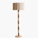 Calypso mid-century modern floor lamp with striped walnut wood and travertine column, pleated beige fabric shade, studio view