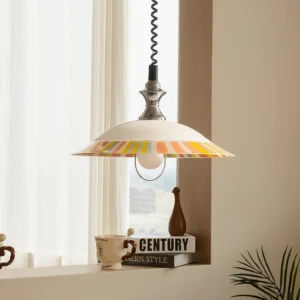 Retro striped saucer pendant light displayed in warm neutral home interior by windowsill, demonstrating vintage ambiance