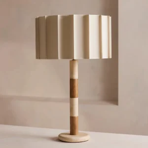 Calypso travertine table lamp three-quarter angle on interior tabletop displaying segmented travertine and walnut wood construction details