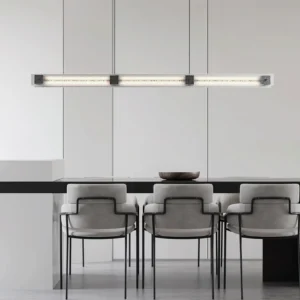 Camacho black linear chandelier in modern dining room, suspended above dining table with upholstered chairs