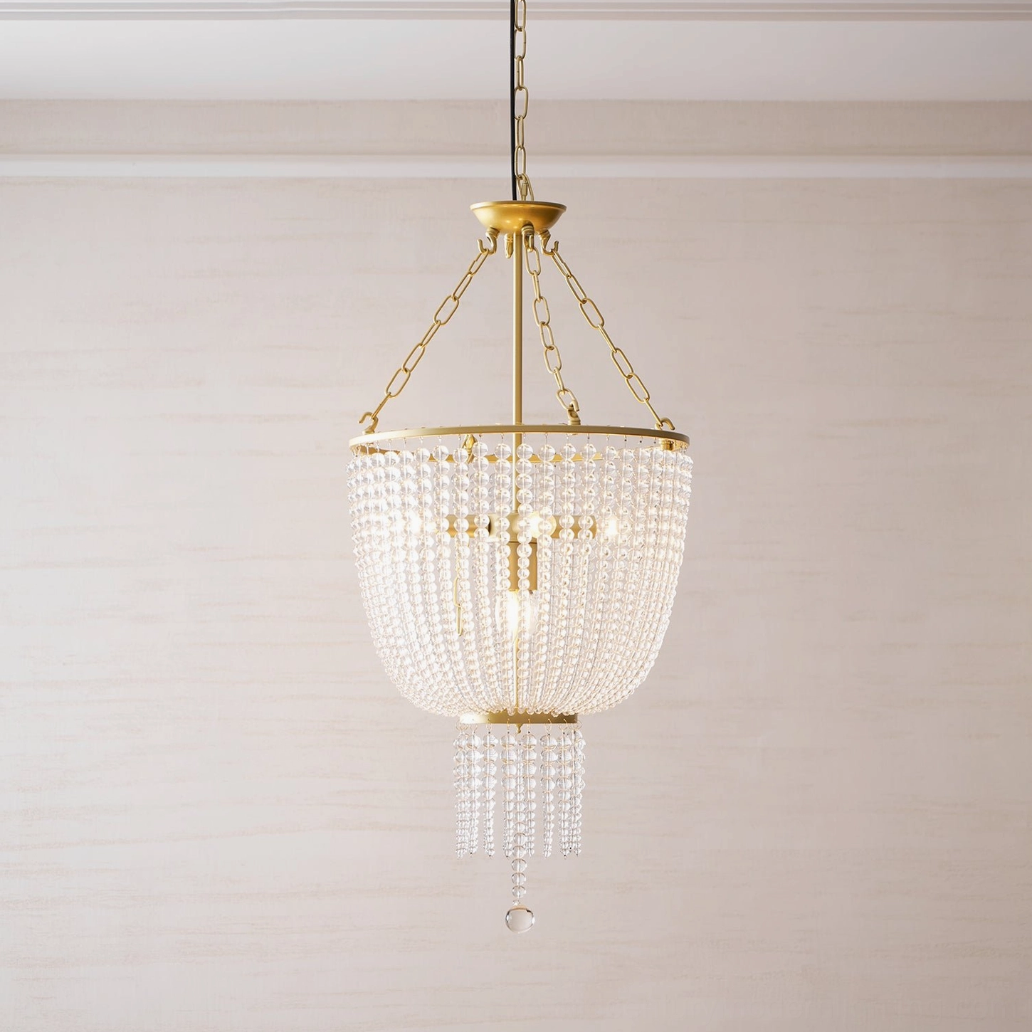 Close-up of Campana golden brass chandelier showing tiered crystal bead construction and light refraction
