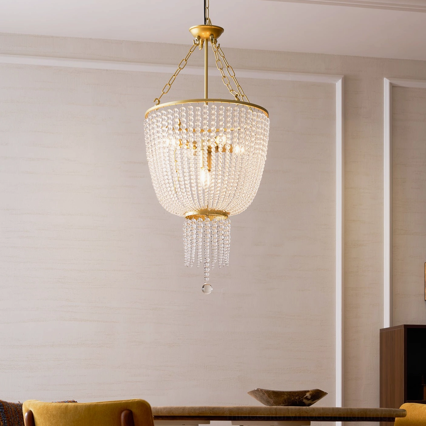 Campana gold chandelier displaying elegant crystal glass bead layers and warm light reflection
