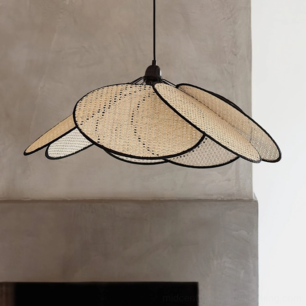 Textured rattan petal pendant light with black-edged petals displayed against fireplace accent wall, emphasizing handwoven design details