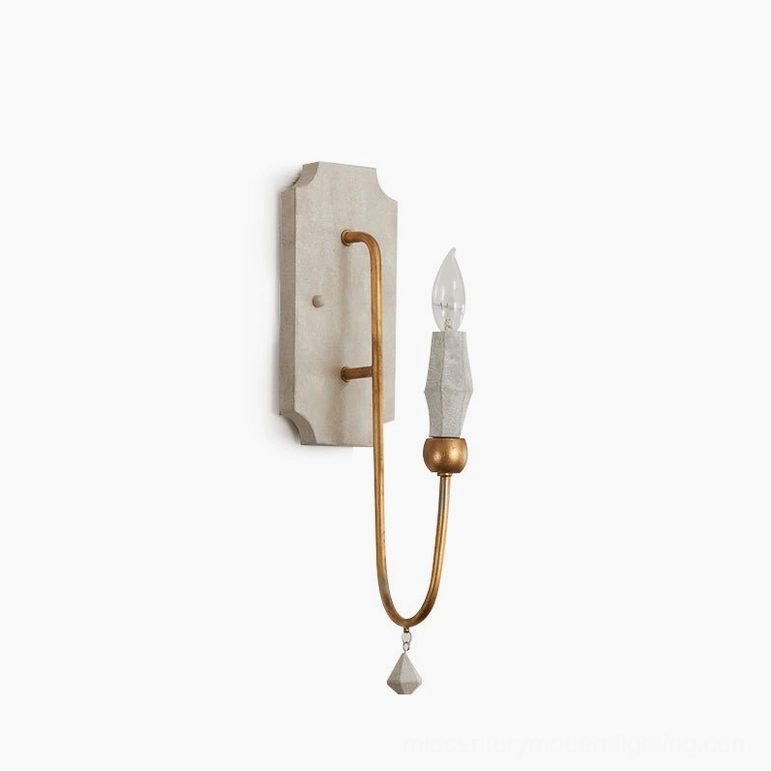 Faceted stone-style candle bulb sleeve with off-white wood backplate and gold metal arm against white studio background