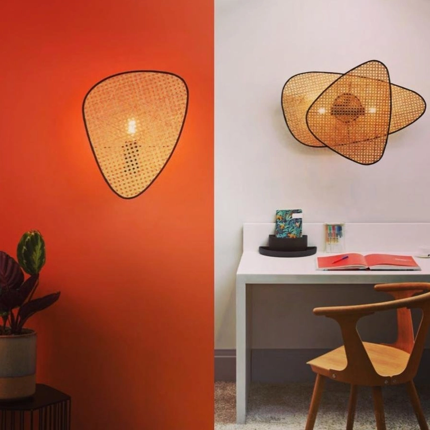 Modern rattan wall lamps in home office corner with terracotta accent wall and wooden desk furniture showing scale and styling