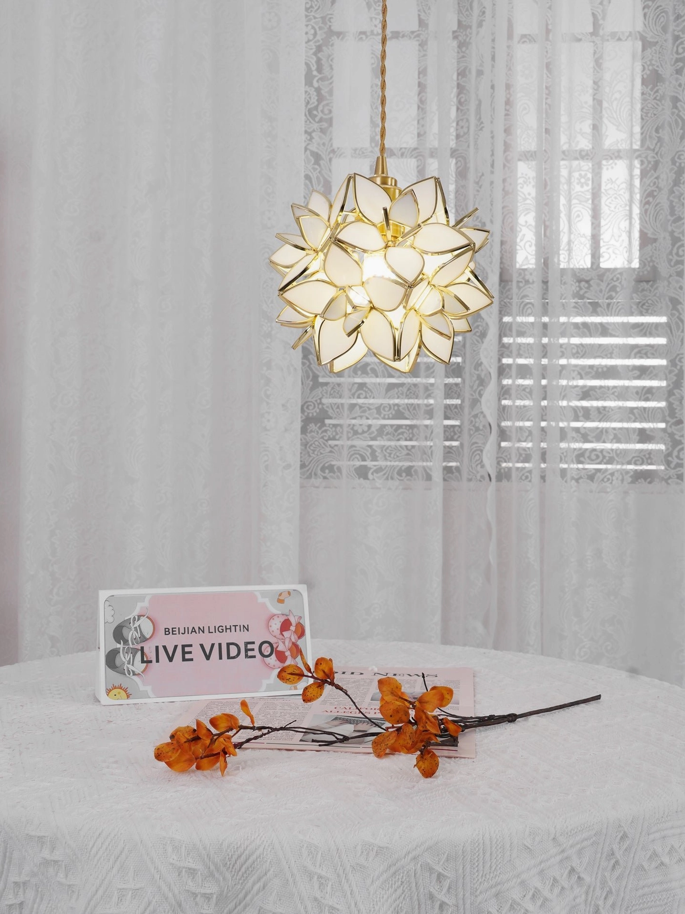 Capiz pendant warm lighting effect illuminating botanical flower form with soft diffused radiance