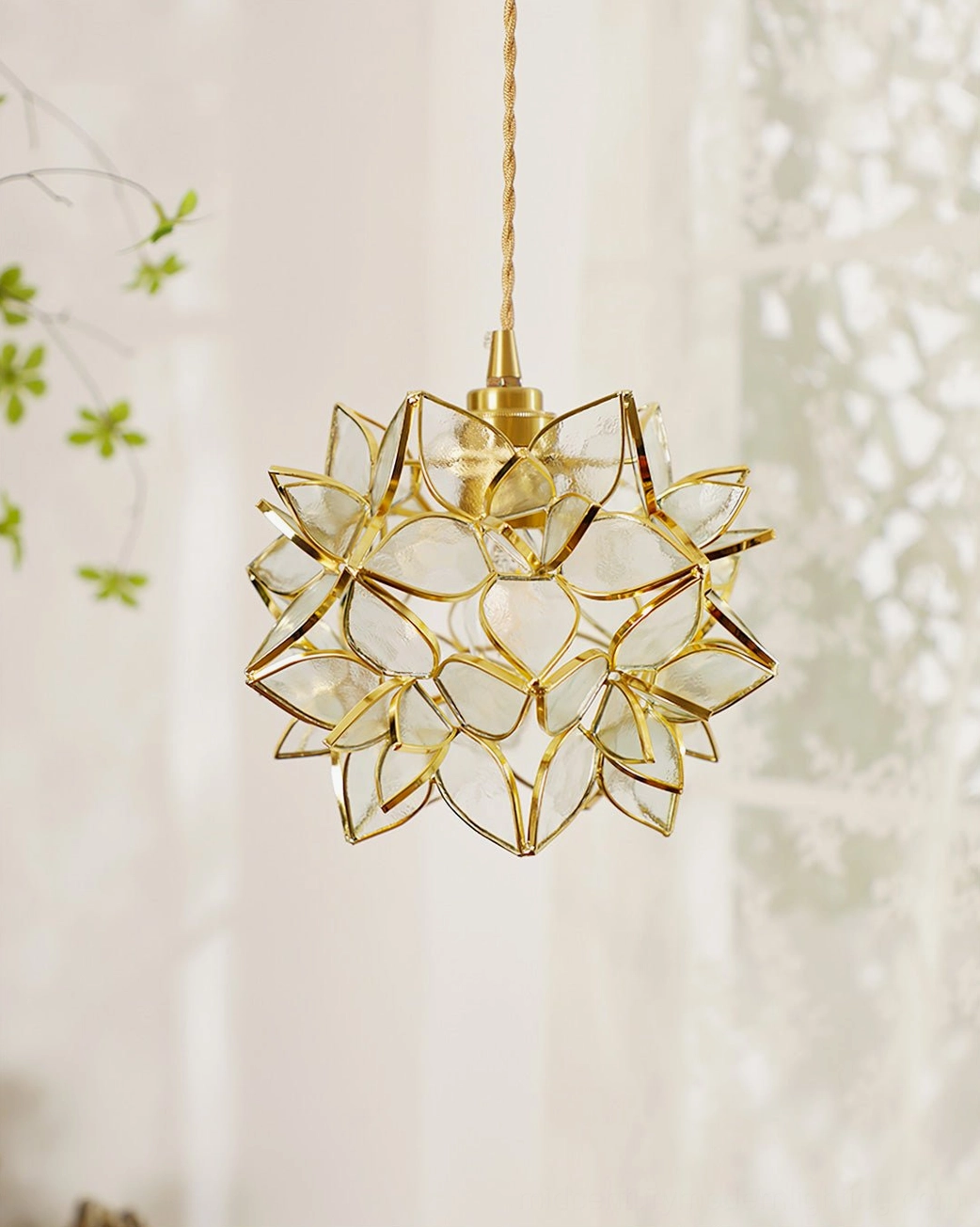 Capiz pendant lamp in home interior showing brass finish and translucent glass sphere silhouette
