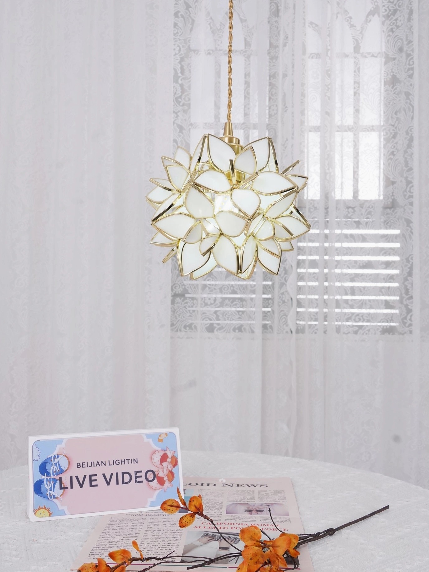 Compact Capiz flower pendant lamp displayed in minimalist interior with modern romantic aesthetic