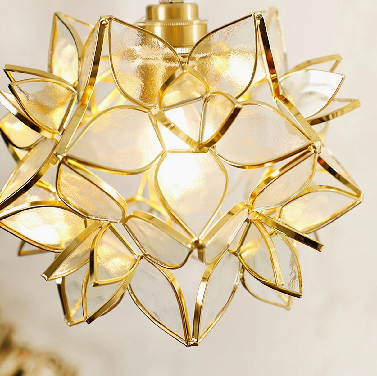 Close-up detail of Capiz pendant showing translucent frosted glass petals arranged on brass armature with illuminated bulb