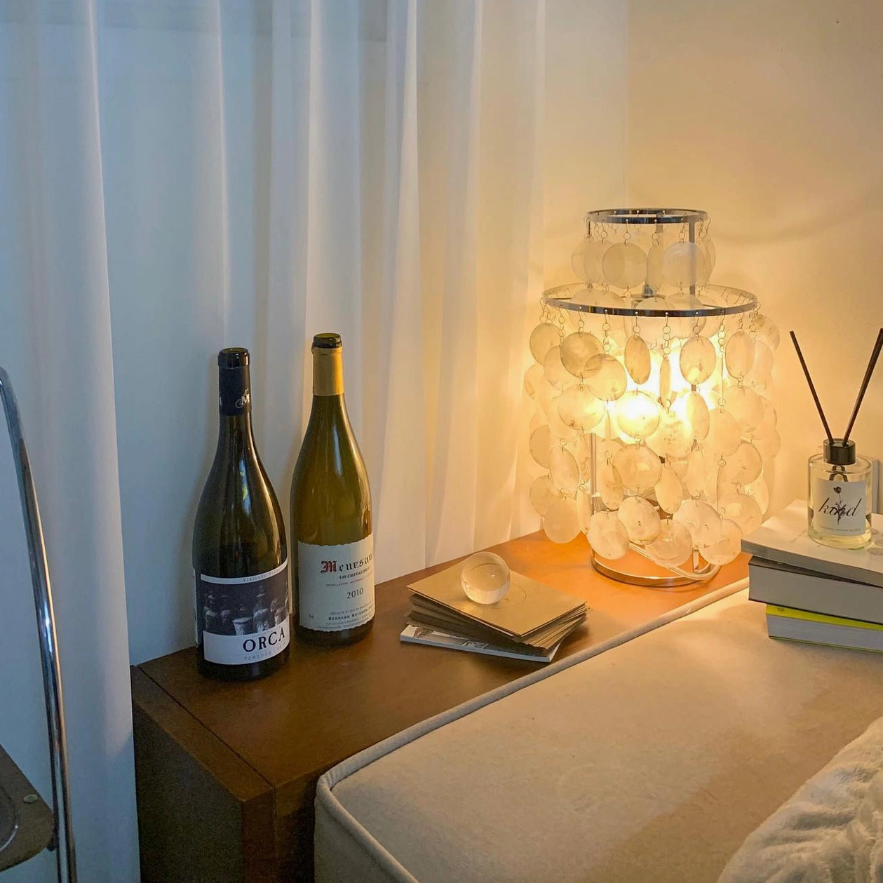 Coastal-inspired capiz shell table lamp in bohemian home interior ambiance