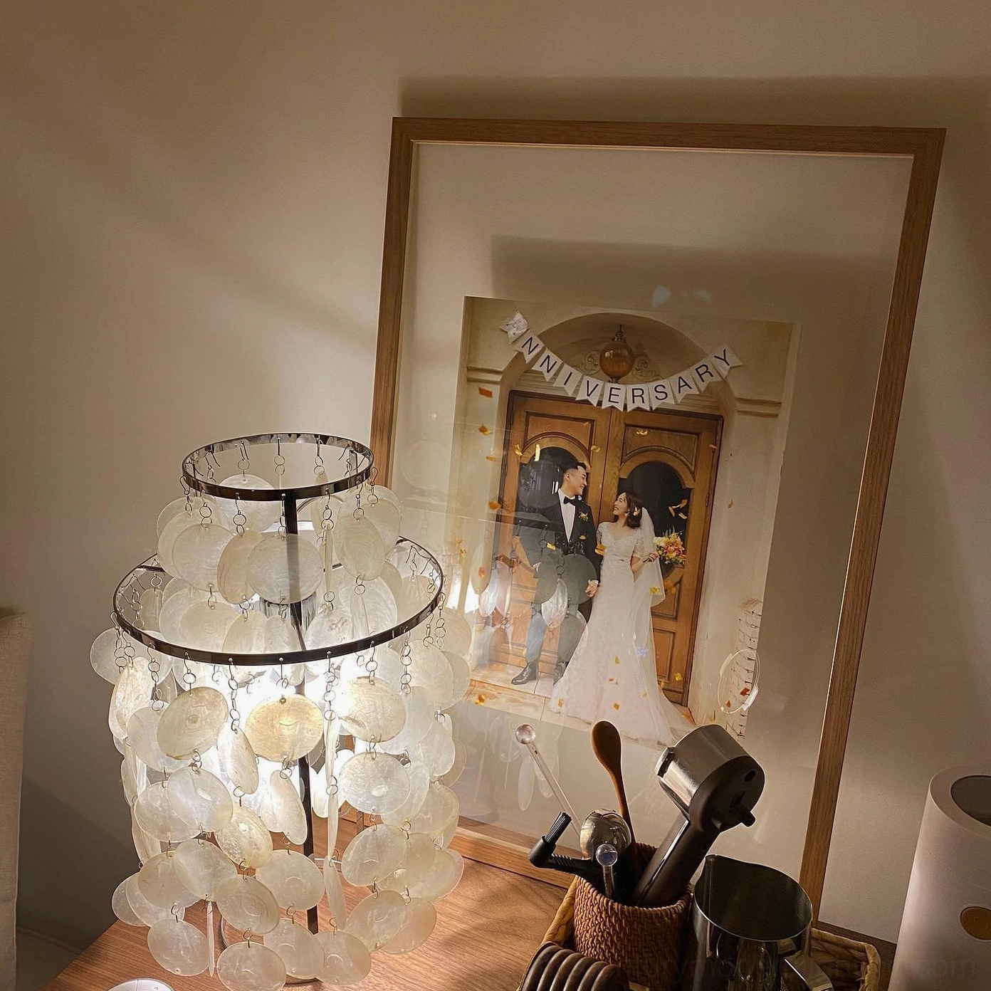 Capiz shell pendant lamp creating soft ethereal light in modern minimalist space