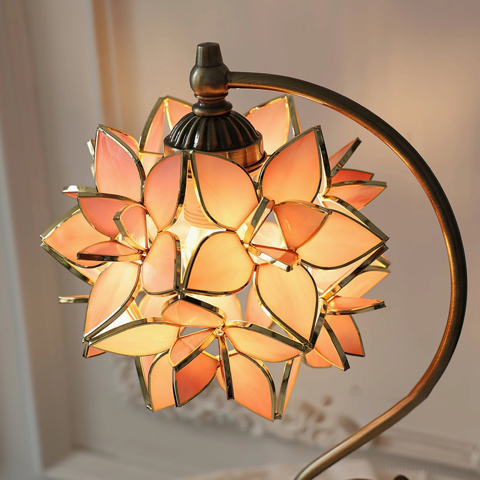 Close-up of lit capiz lamp shade with soft warm glow and detailed stained glass petals, intimate lighting effect
