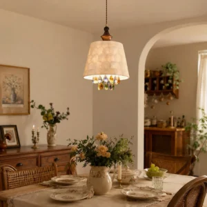 Capiz shell pendant light hanging in warm vintage dining room with beige shade, brass hardware, and traditional wooden furniture