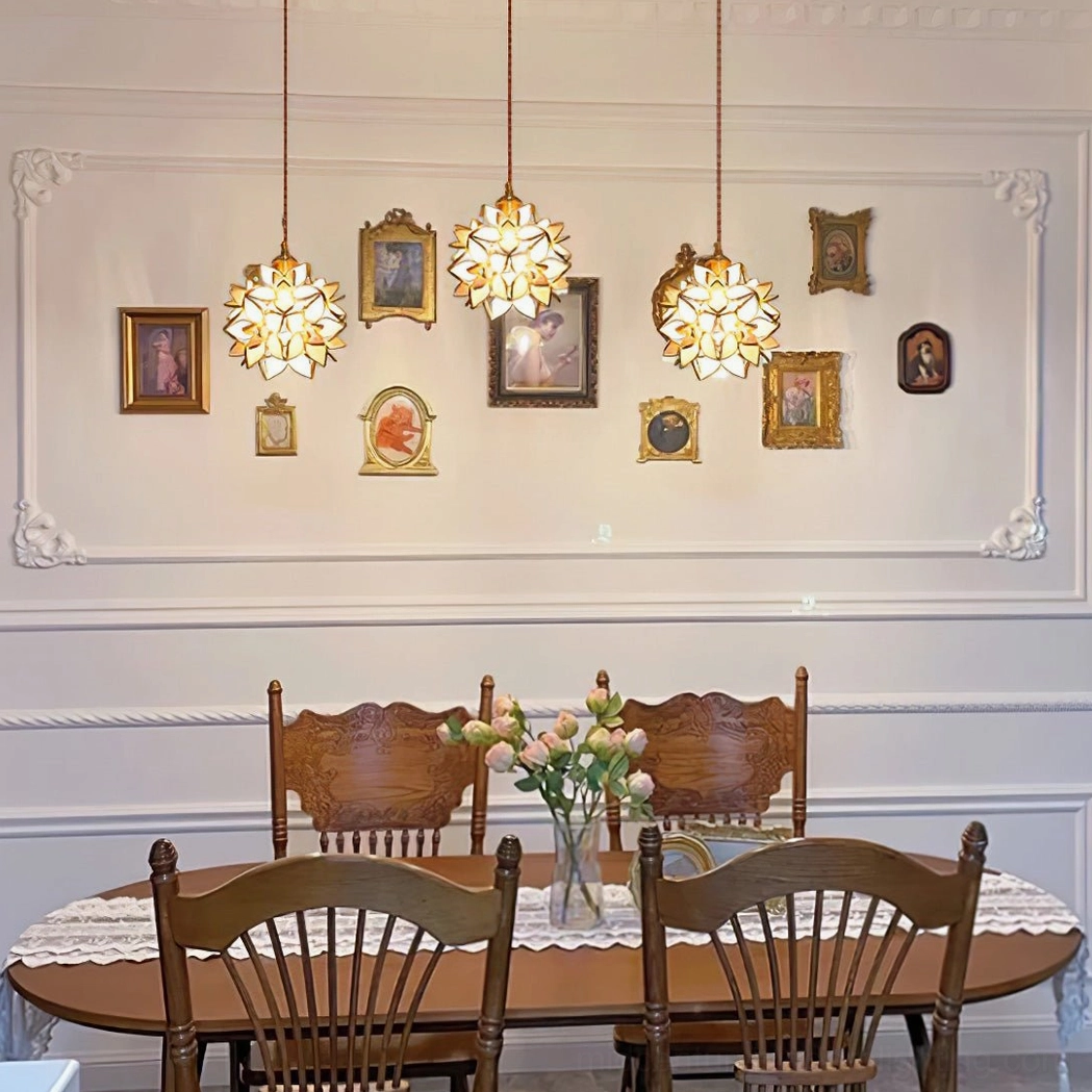 Capiz pendant lamp displaying sculptural floral design with warm brass accents in lifestyle setting