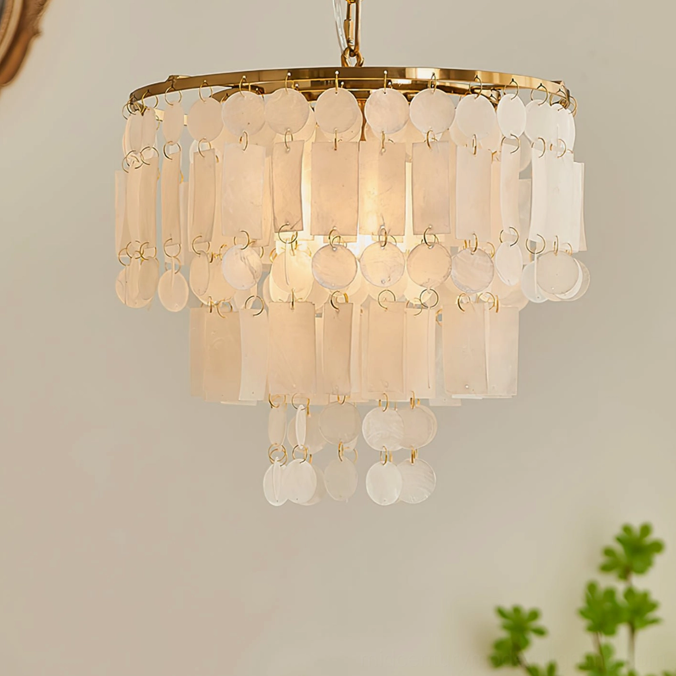 Capiz shell chandelier artistic composition showing natural shell variations and brass frame craftsmanship, elegant luxury design