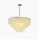 Capiz shell chandelier with tiered white shell design and gold metal frame on white background, luxury coastal lighting fixture