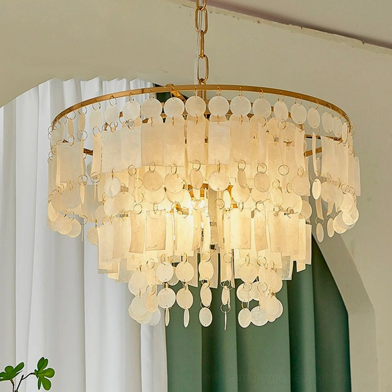 Capiz shell chandelier in romantic cozy luxury setting with warm glowing light and elegant tiered shell layers