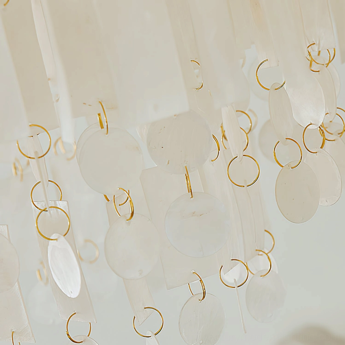 Capiz shell chandelier showcasing sophisticated design with natural shell material and refined brass frame construction details