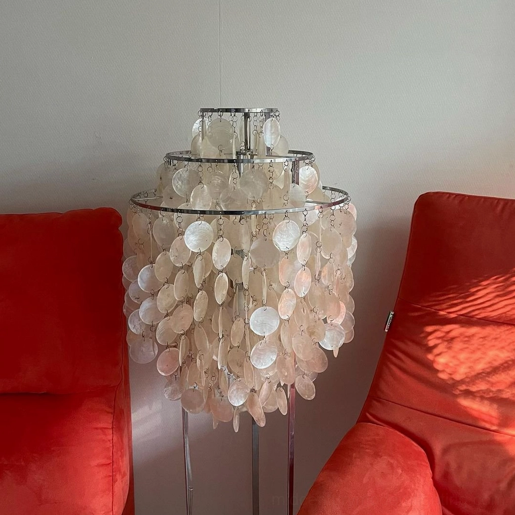 Tiered shell floor lamp with ombre beige capiz shells and chrome metal stand in minimalist living room