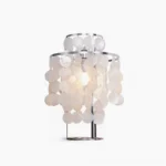Modern mother-of-pearl capiz shell table lamp with stainless steel frame on white background