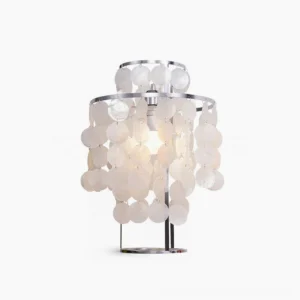 Modern mother-of-pearl capiz shell table lamp with stainless steel frame on white background