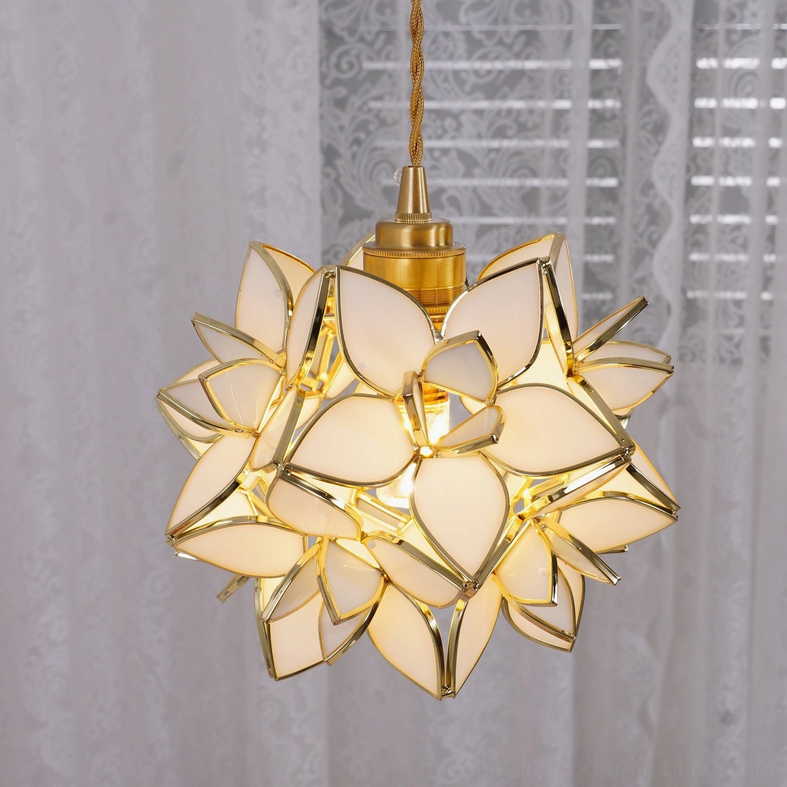 Capiz white frosted glass pendant lamp close-up with lace curtain background showing delicate petal structure