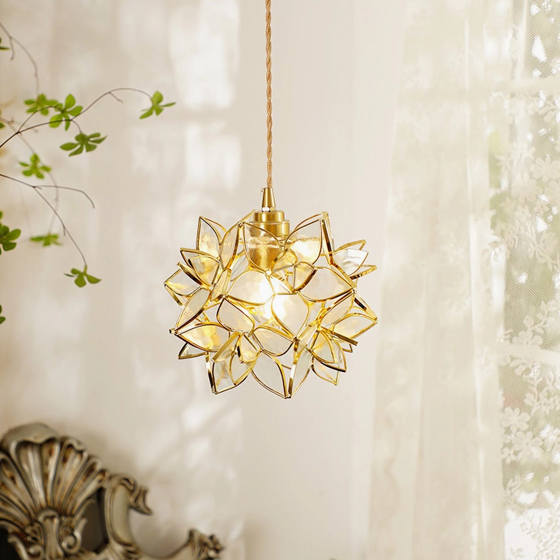 Capiz flower pendant lamp with white frosted glass petals and gold brass fixture in romantic bedroom setting