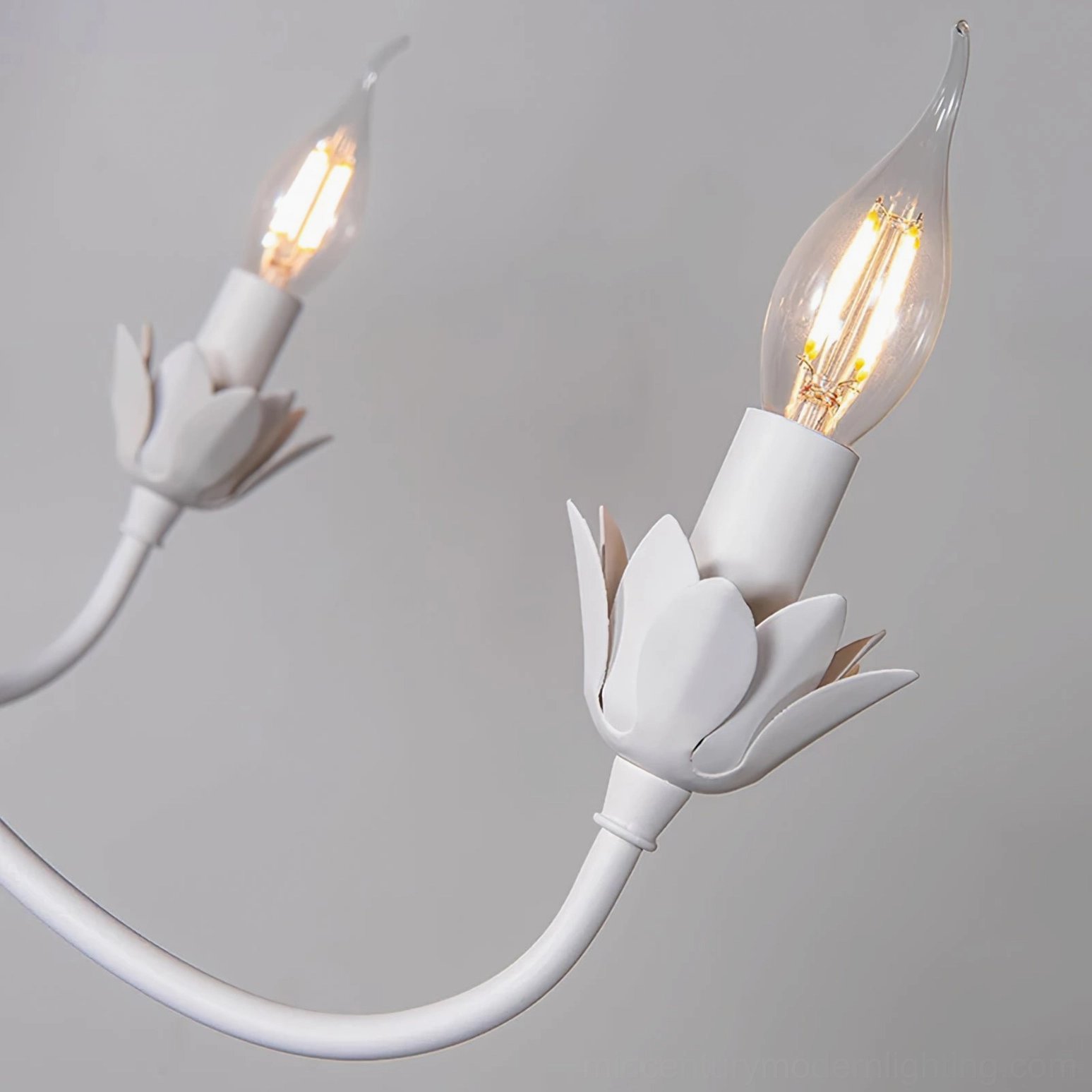 Close-up of Caposile chandelier E14 bulb sockets with lit clear candle LED bulbs
