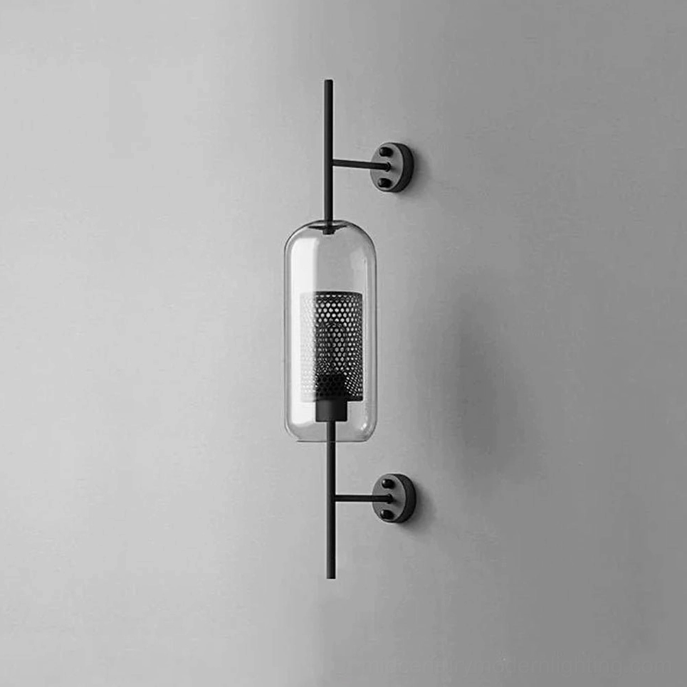 Modern glass sconce showing capsule form with black metal mounting frame