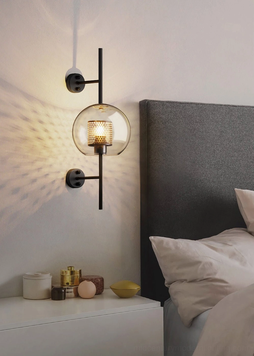 Capsule glass sconce showing elongated form and honeycomb mesh pattern