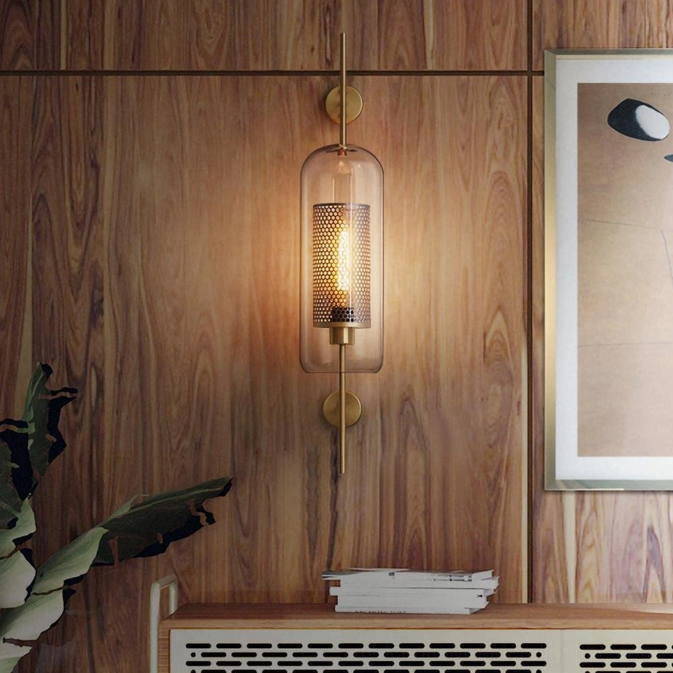 Elongated capsule glass wall lamp with warm brass mounting, side profile bedroom lighting