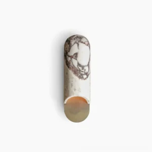 Capsule wall lamp front view with purple-veined marble and warm glowing LED base on white backdrop