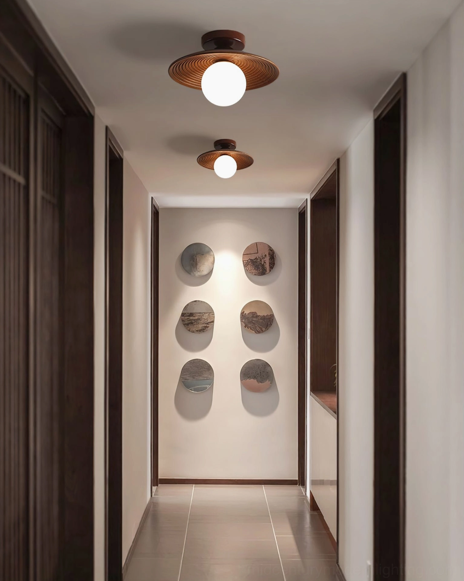 Row of Carapace ceiling fixtures in contemporary residential hallway with neutral walls and art display