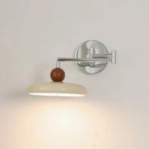 Carins mid-century modern wall lamp illuminated with warm ambient light in minimalist bedroom
