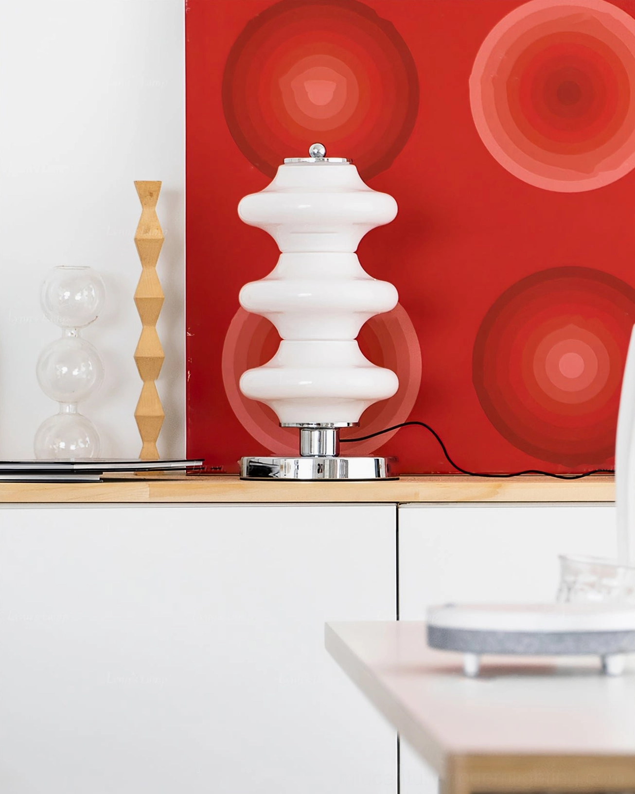 Carlo table lamp styling with console furniture and red geometric wall art in coordinated retro home decor arrangement