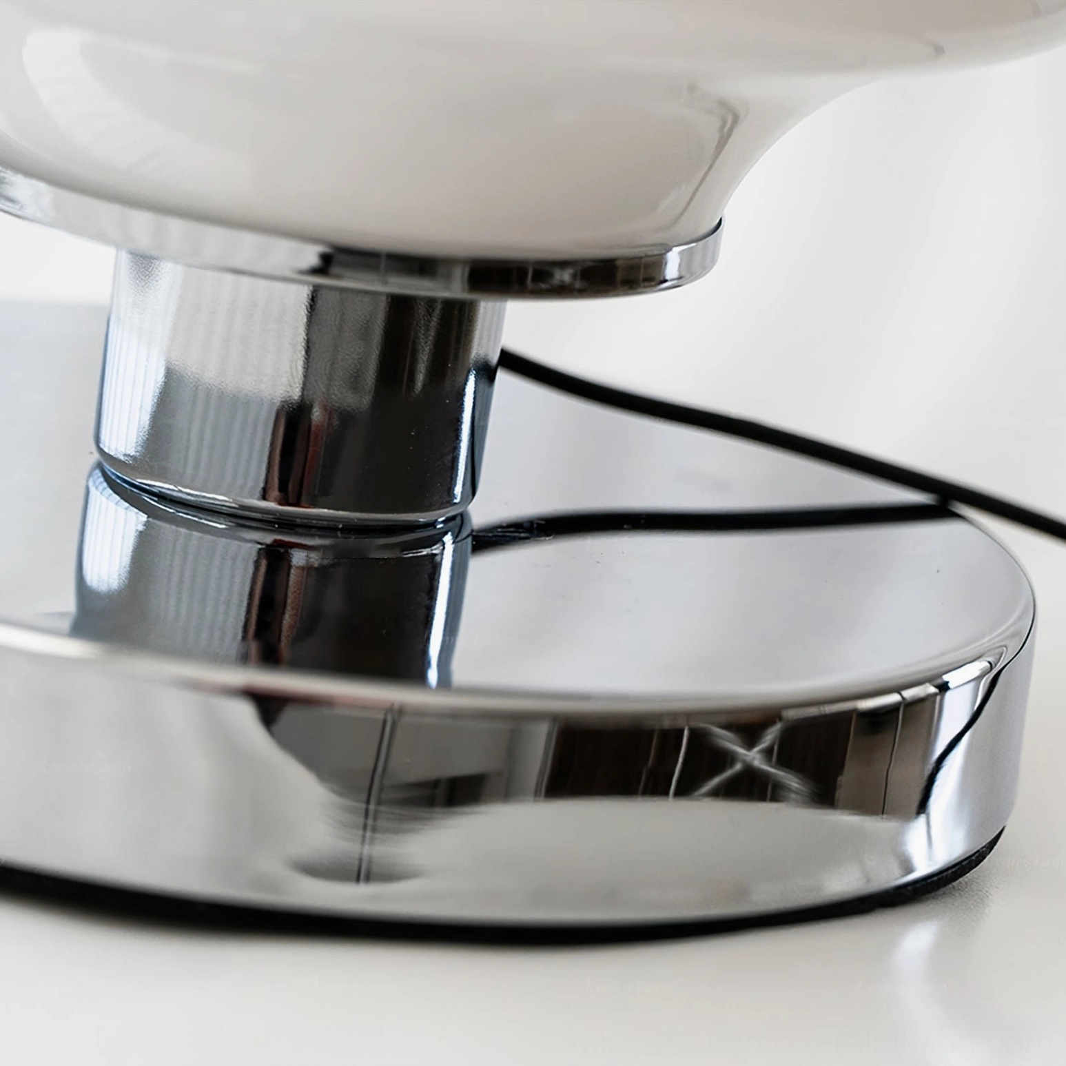 Carlo table lamp shade top detail showcasing chrome finial, smooth milky white opal glass segments and layered construction