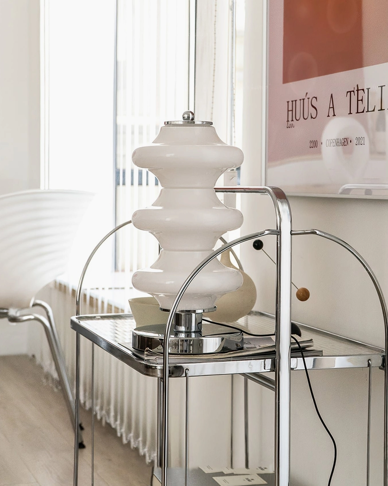 Carlo midcentury lamp high side angle view showing white stacked glass shade and chrome metal fixtures in bright entryway