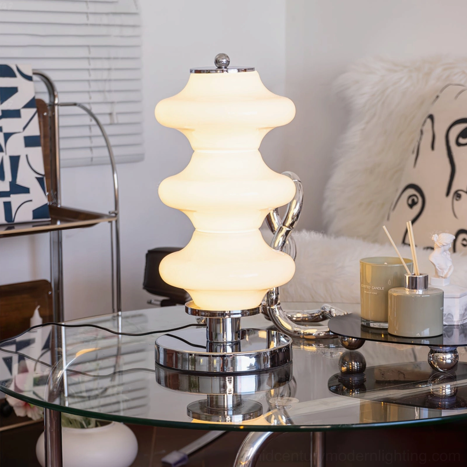 Lit Carlo table lamp glowing warmly in modern dining room with polished chrome accents and layered glass diffuser
