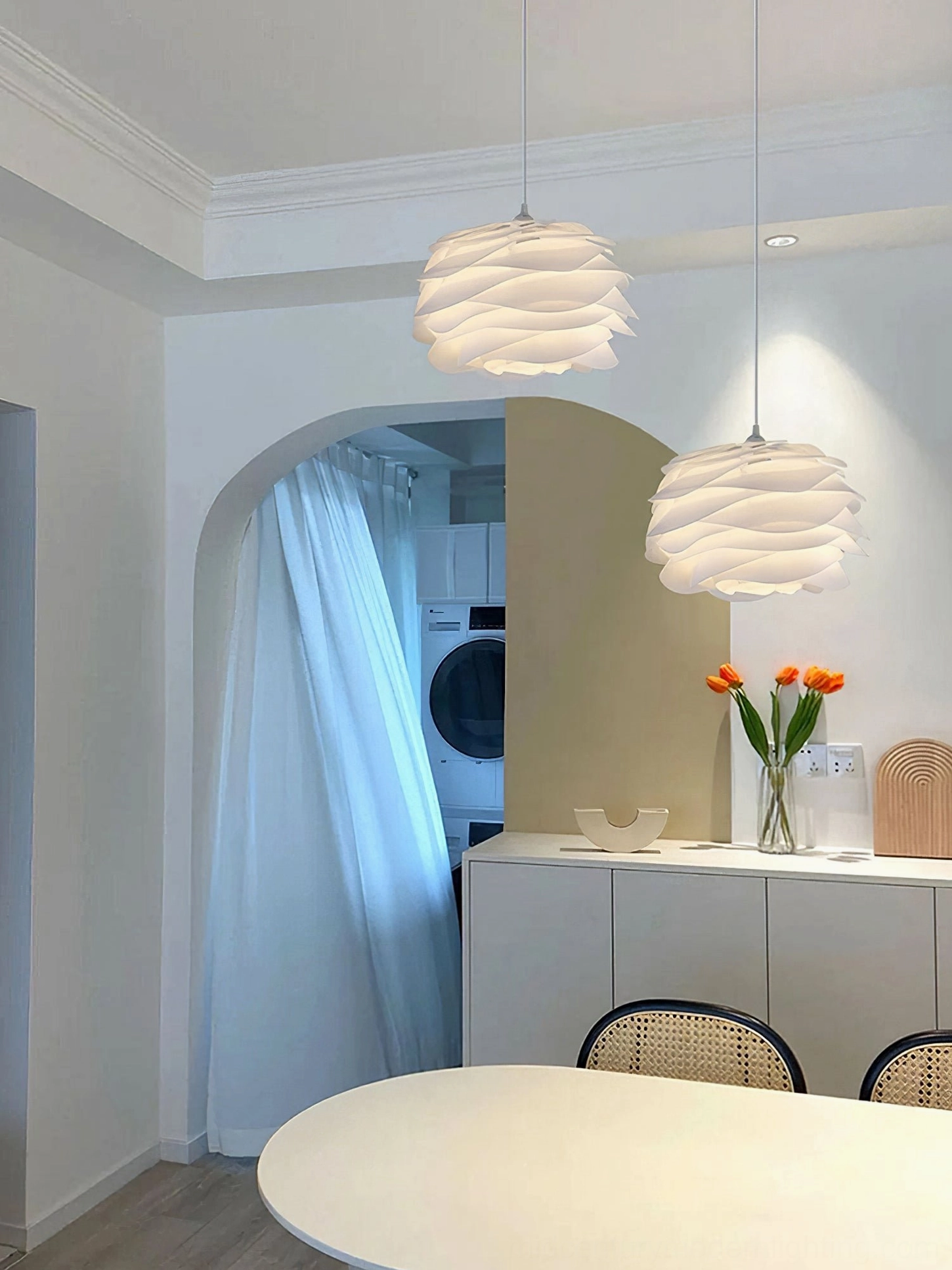 Dual Carmina pendant lights in modern kitchen nook, matching white pendant fixtures over countertop