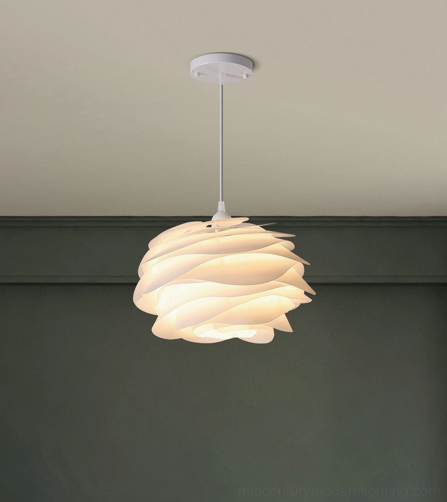 Carmina wavy petal pendant lamp against dark green accent wall, matte white unlit shade detail