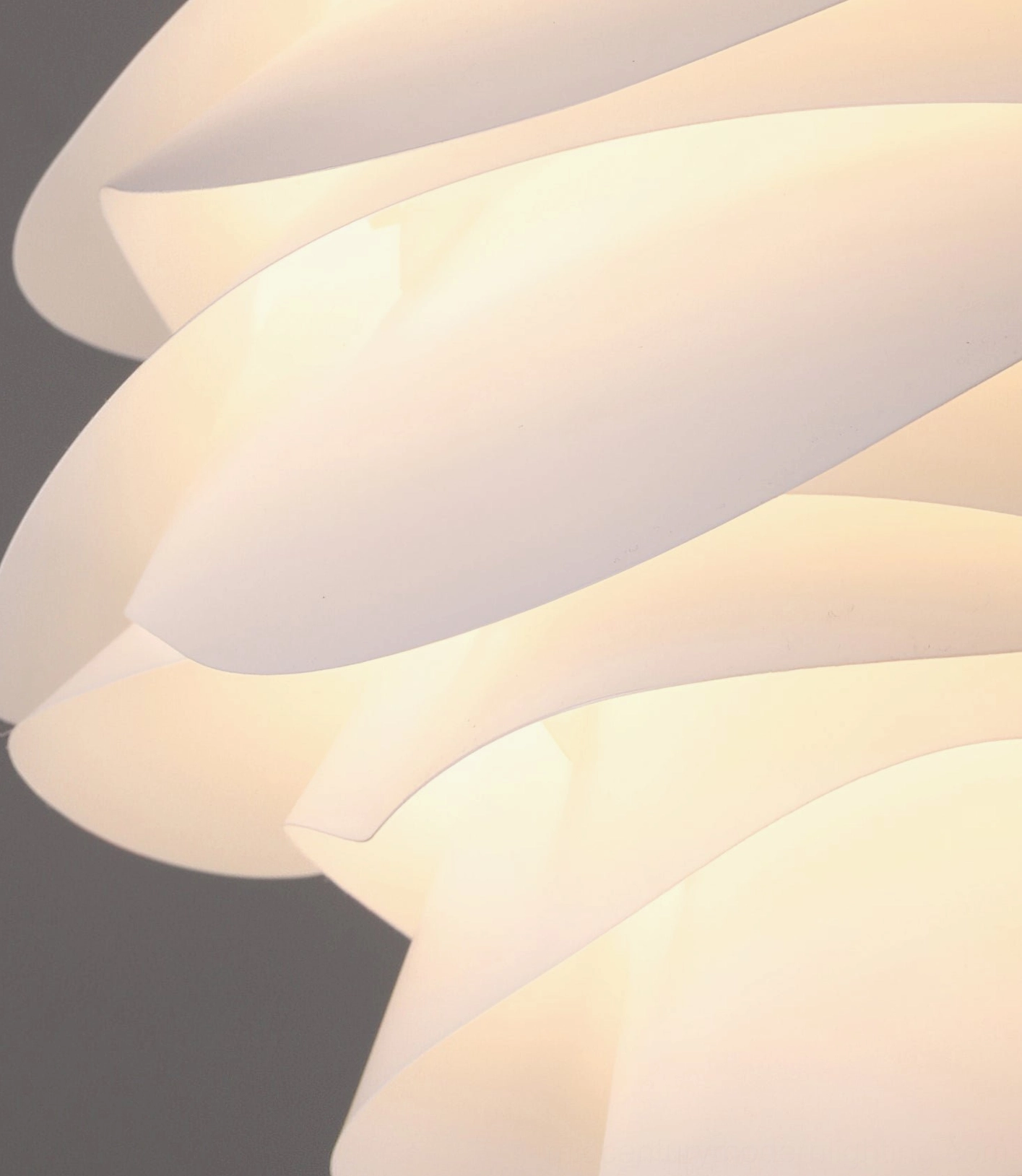 Close-up macro view of Carmina pendant shade showing curved matte white translucent petals, layered ruffled texture detail