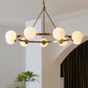 Lit Carolee brass chandelier in luxury dining room with arch doorway, warm ambient lighting from frosted glass shades