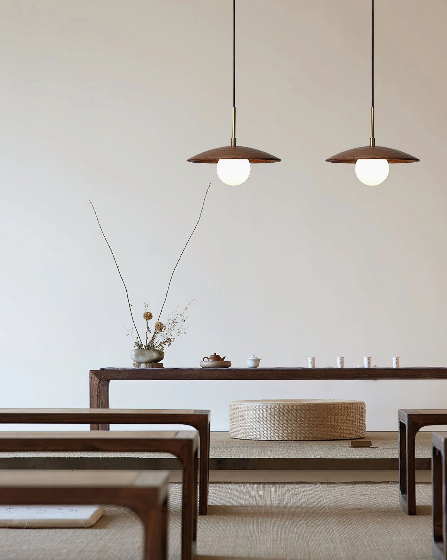 Two matching Caroll pendant lights in japanese-style tea room with wabi-sabi minimalist aesthetic