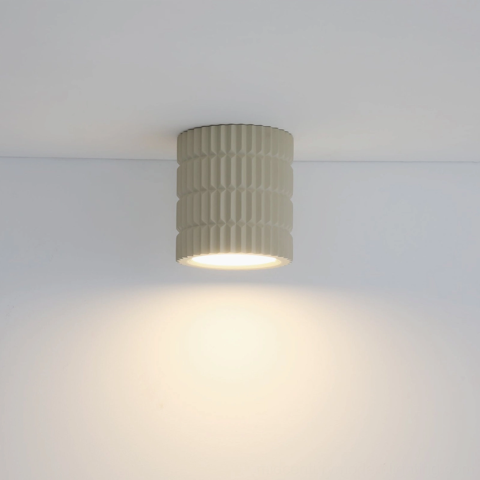 Carran ceiling light low-angle front view casting warm light pool on ceiling-wall interface