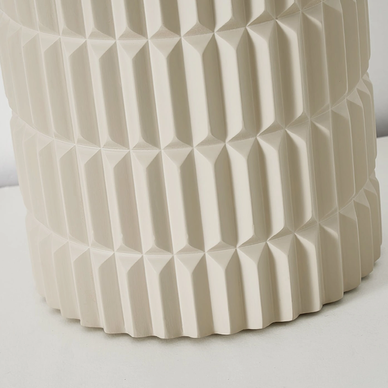 Close-up macro photography of Carran ceiling light's matte vertical ribbed surface texture