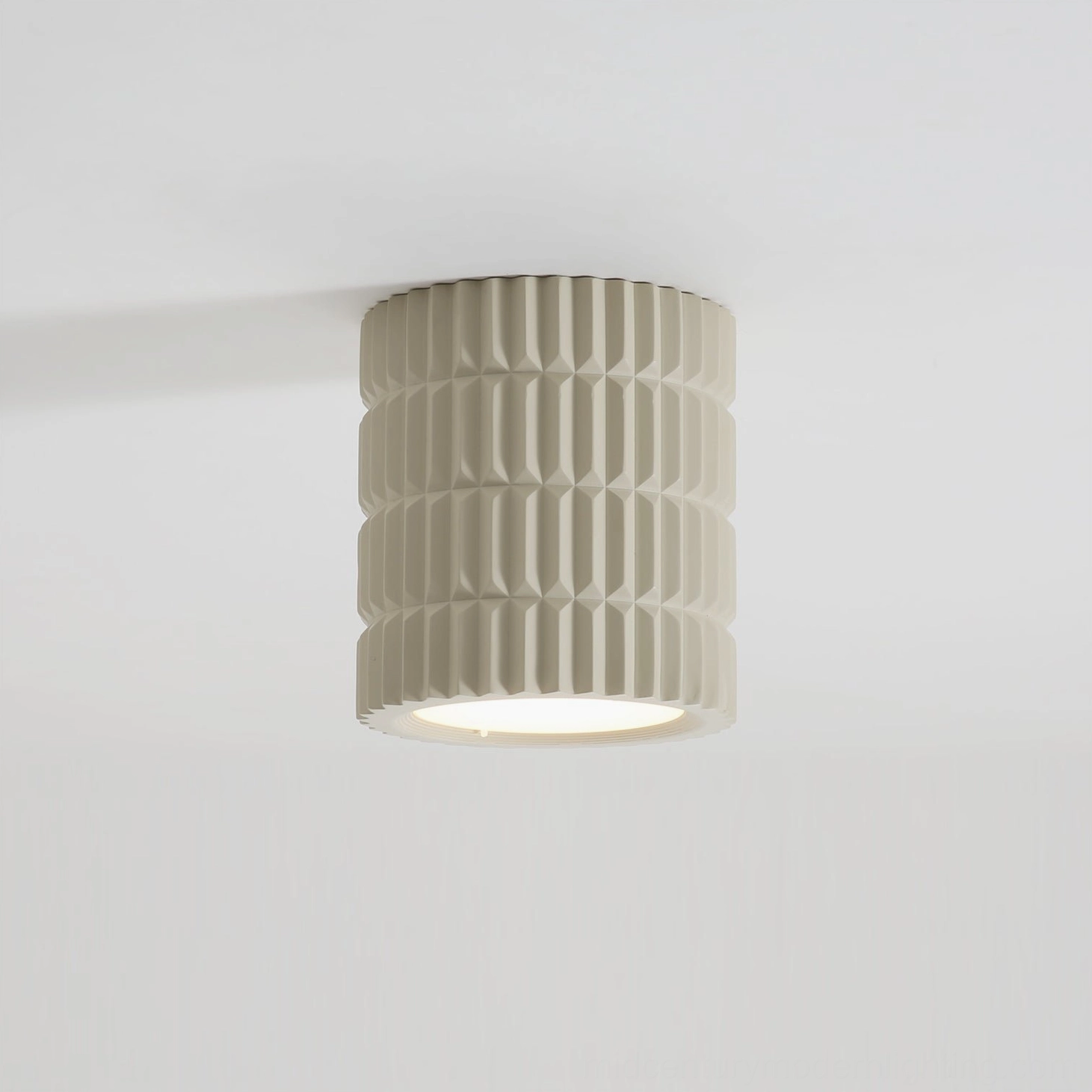 Modern Carran ceiling lamp mounted on white ceiling, emitting warm downlight in minimalist interior