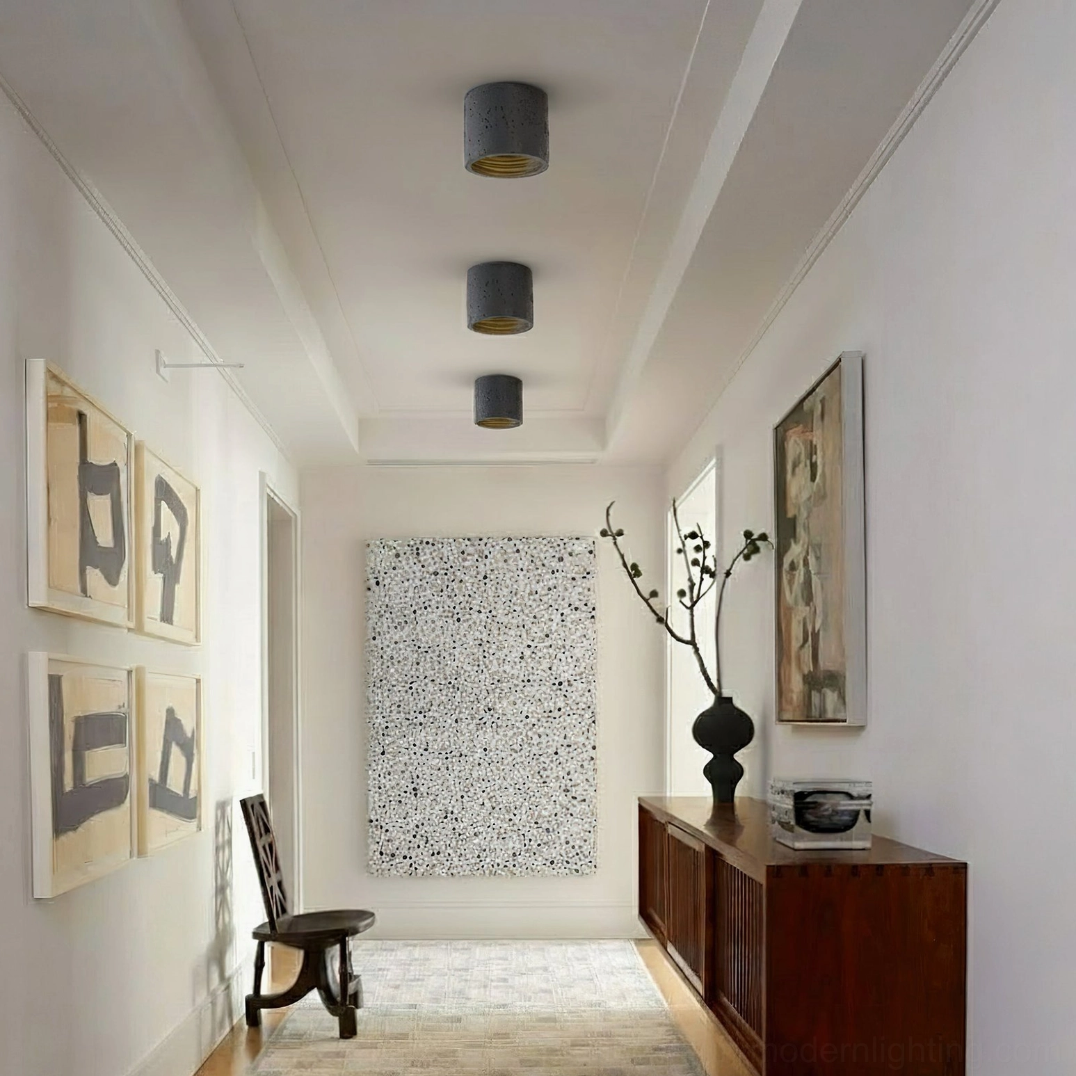 Multiple Carso pendant lights in modern home entryway, dark grey finish with boho decor